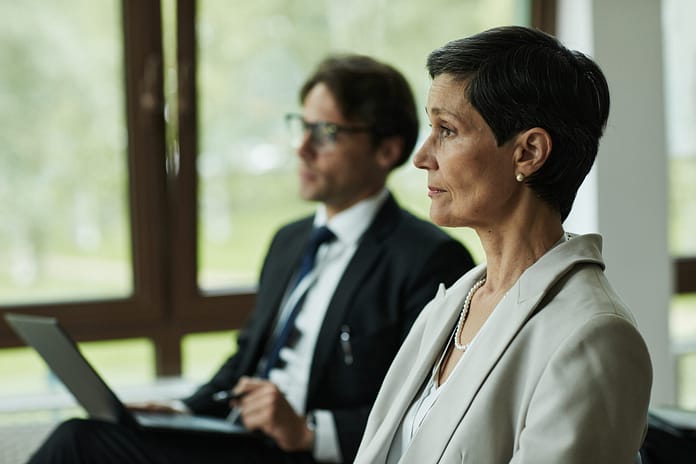 Middle Aged Caucasian Woman Attending Business Meeting with Colleague
