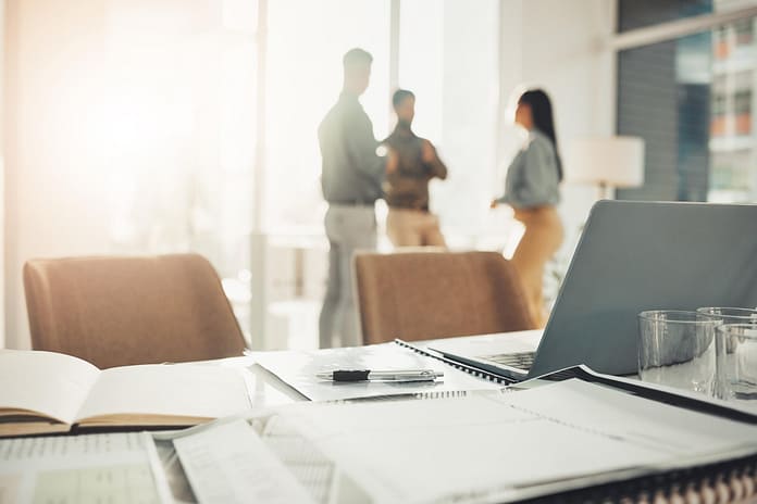 Desk, paperwork and notebook with laptop in office, professional workspace and setup, folder and planning. Strategy, documents and research, busy with business proposal with meeting and information